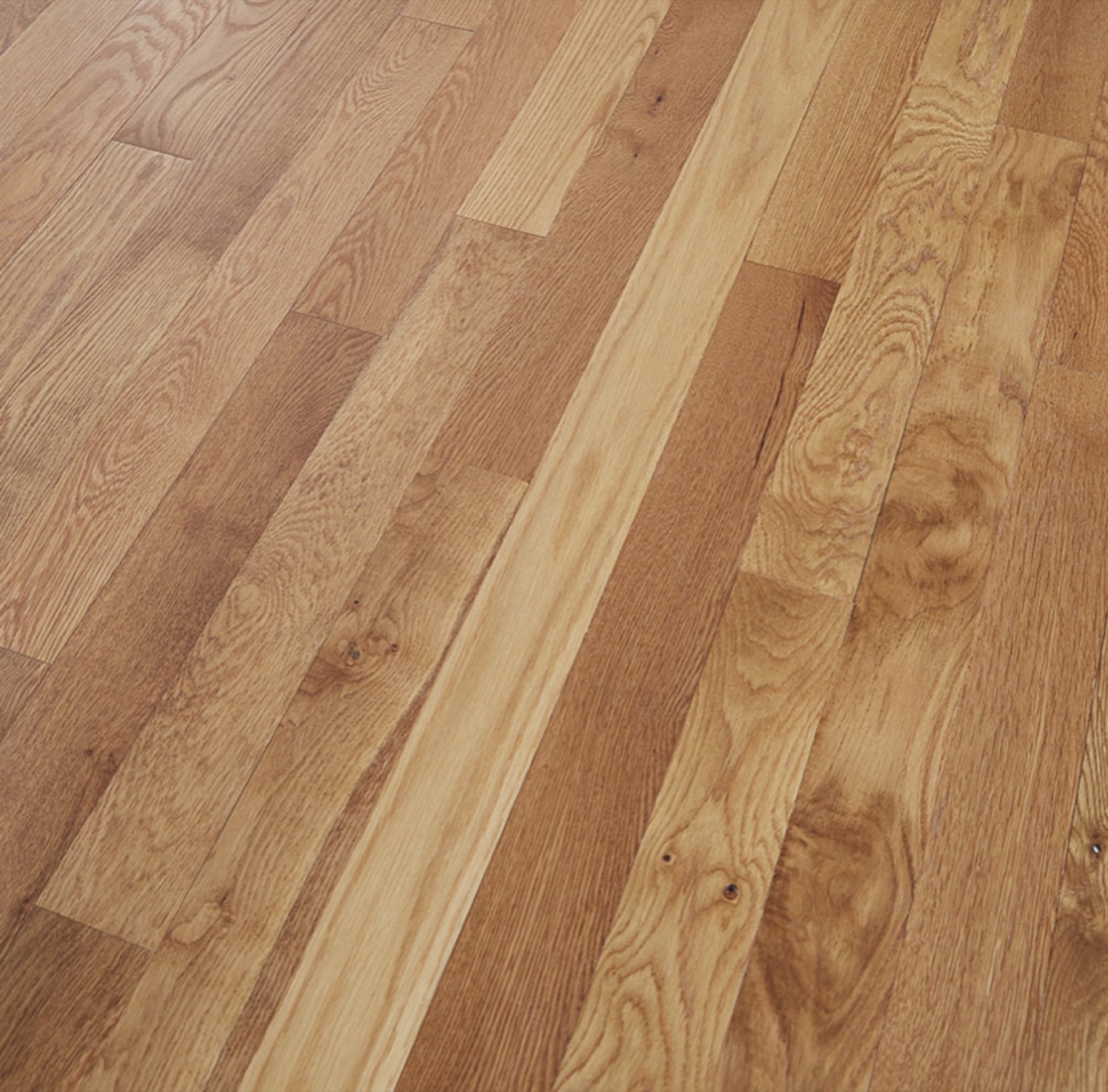 Freshly sanded and refinished solid oak flooring in a natural satin finish, bringing a tired floor back to life.
